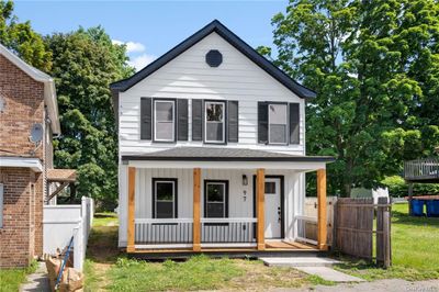 View of front of house with a porch and a front yard | Image 1