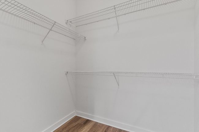 Spacious closet with dark wood-style floors | Image 20