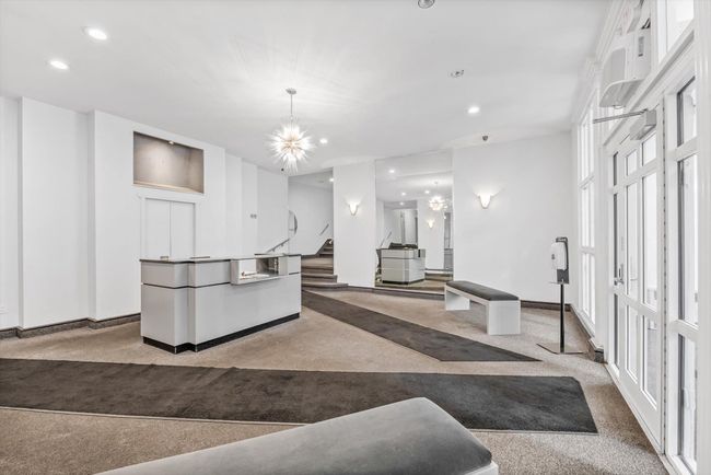 Kitchen featuring carpet flooring, recessed lighting, a chandelier, and white cabinetry | Image 14