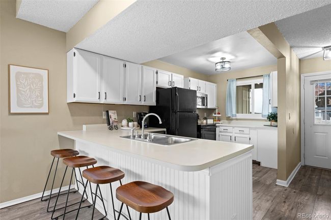 Adorable kitchen with eat-at counter and lots of cabinets! | Image 8