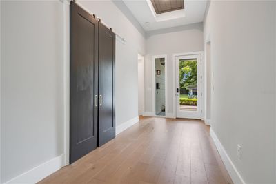 Open Foyer with sliding doors leading to first floor office space. | Image 3