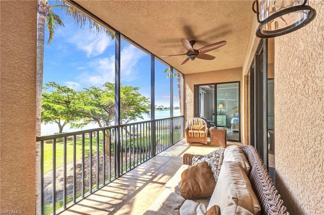 Sunroom featuring a water view and a ceiling fan | Image 29