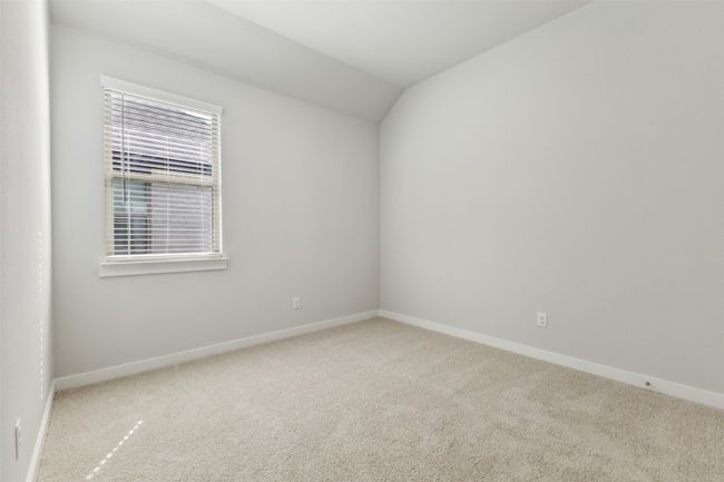 Spare room with carpet, baseboards, and vaulted ceiling | Image 15