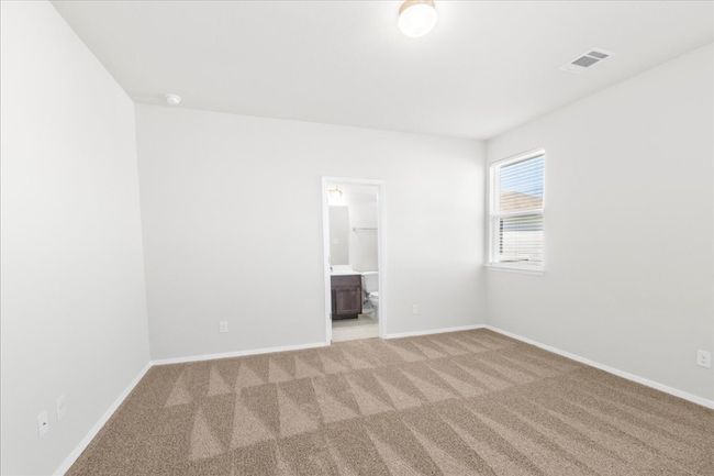 Carpeted empty room with visible vents and baseboards | Image 13
