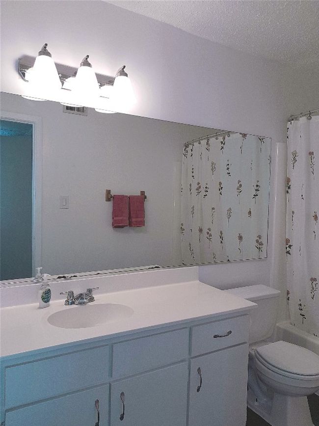 Bathroom with updated light fixture and cabinet handles | Image 9