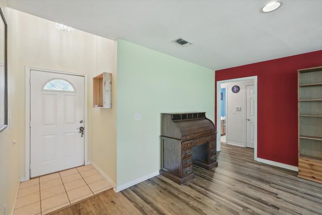 Entryway with visible vents, baseboards, and wood finished floors | Image 5