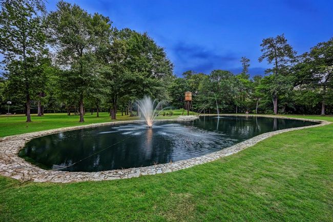 The 12 foot deep pond with stone lined exterior includes a fountain and water tower feature. | Image 47