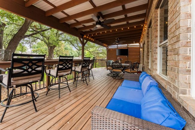 Deck featuring outdoor dining area, a ceiling fan, and an outdoor living space | Image 34