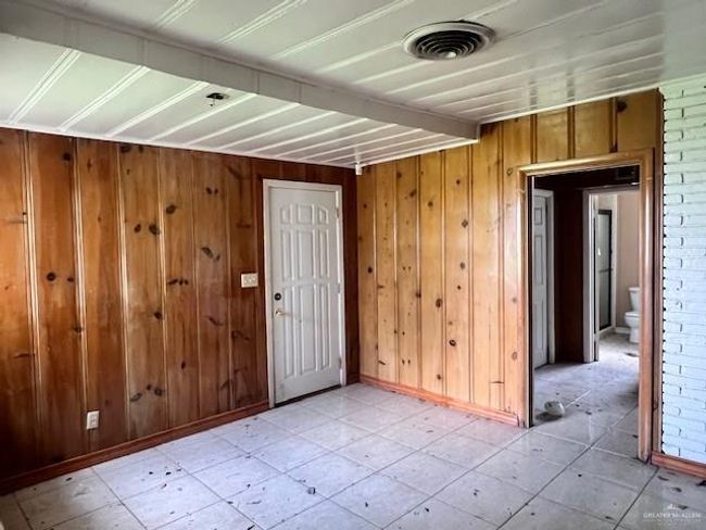 Foyer with wood walls and baseboards | Image 13