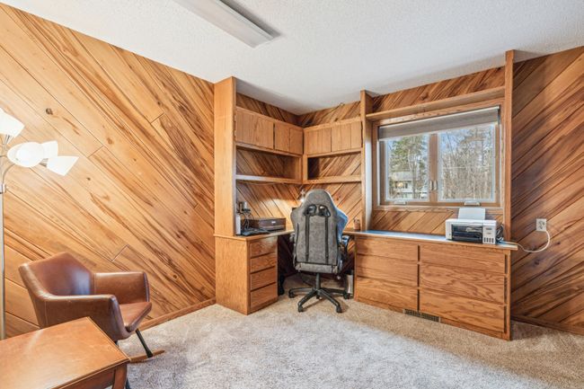 2nd lower level bedroom with plush carpet and built ins perfect for a home office | Image 29