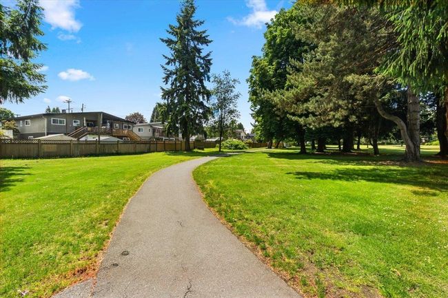View of property's community featuring a yard and fence | Image 39