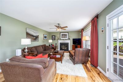 Living room featuring light hardwood / wood-style flooring and ceiling fan | Image 3