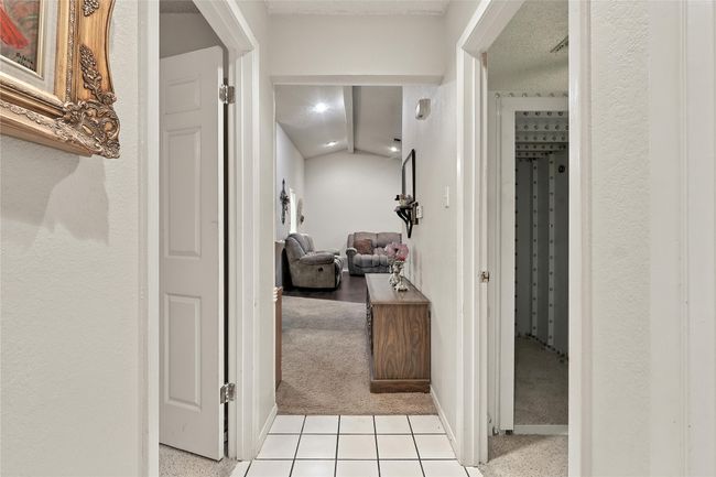 Hall with light colored carpet and light tile patterned flooring | Image 29