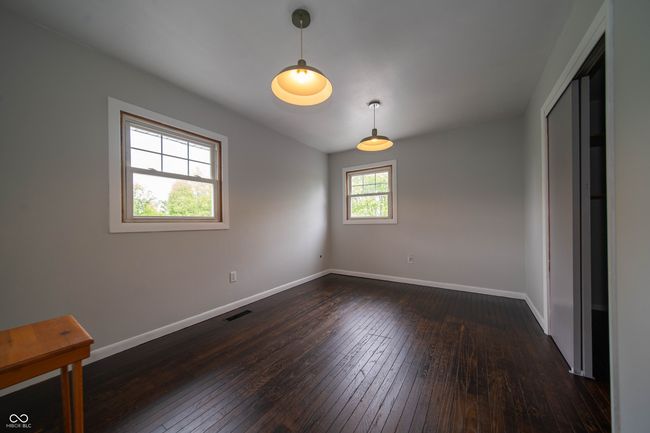 spare room with dark wood-style flooring and baseboards | Image 30