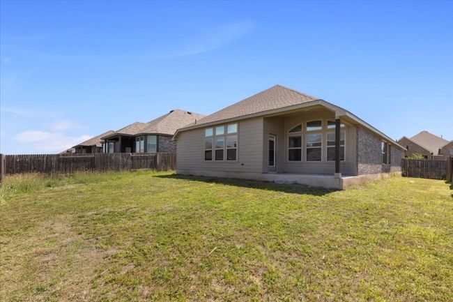 Back of property with a fenced backyard and a lawn | Image 25