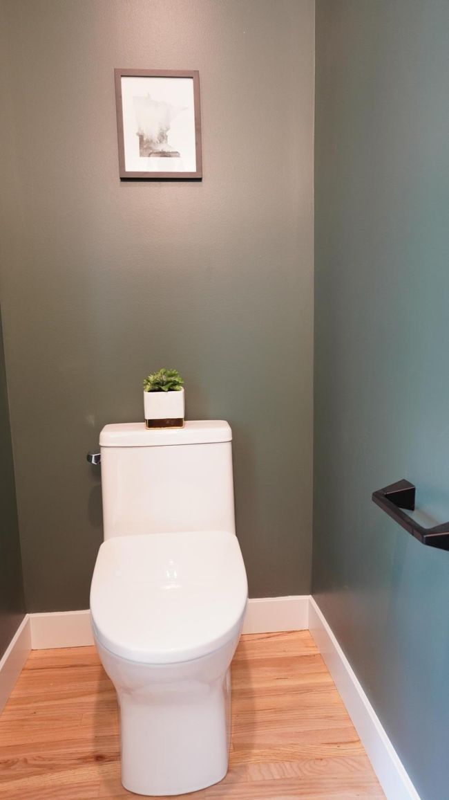 All bathrooms, including this sophisticated main level powder room, feature brand new Swiss Madison toilets and clean, modern plumbing fixtures. | Image 38