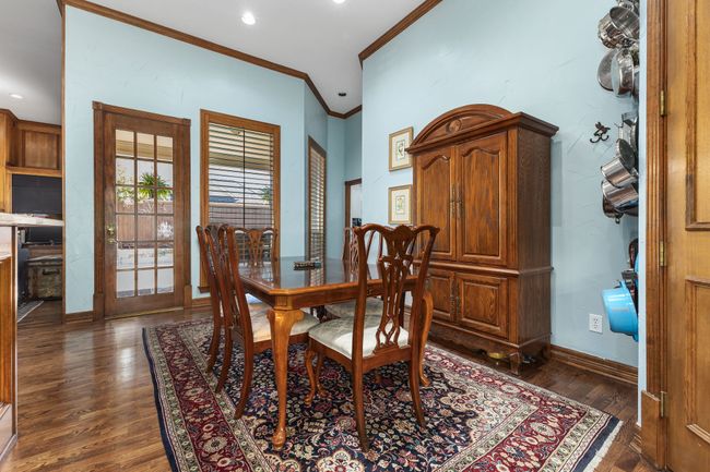 Dining space featuring wood-style floors, ornamental molding, and baseboards | Image 9