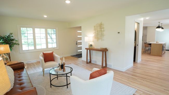 The light, bright and spacious front living room is a wonderful place to both relax and entertain. It highlights newly refinished hardwood floors, brand new lighting, and vantage points to both the kitchen area and the front entry. | Image 5