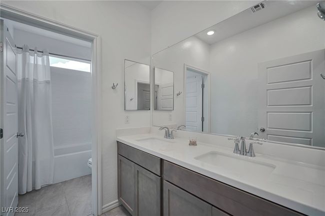 Full bathroom featuring visible vents, a sink, toilet, and double vanity | Image 24