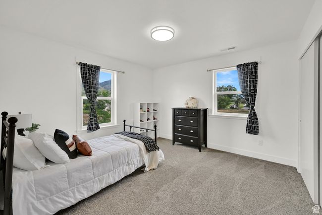 Bedroom with light carpet and baseboards | Image 39