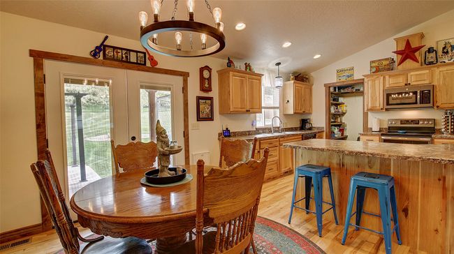 Dining area featuring a chandelier, light wood-style floors, vaulted ceiling, and recessed lighting | Image 16