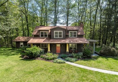 View of front of property featuring covered porch and a front yard | Image 1