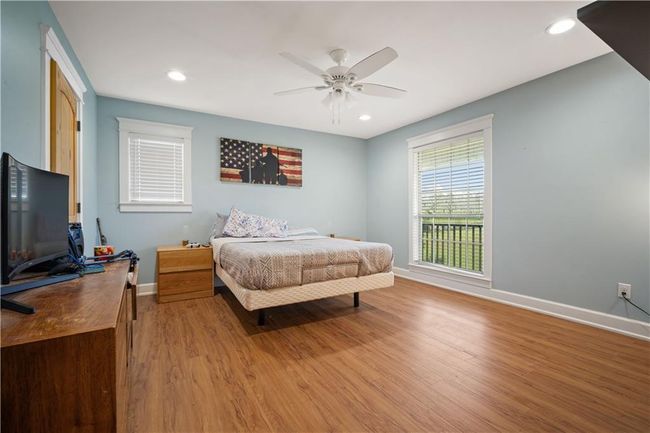 Bedroom with baseboards, recessed lighting, and light wood finished floors | Image 19