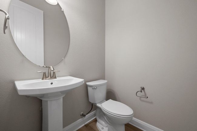 Half bathroom with toilet and wood finished floors | Image 24