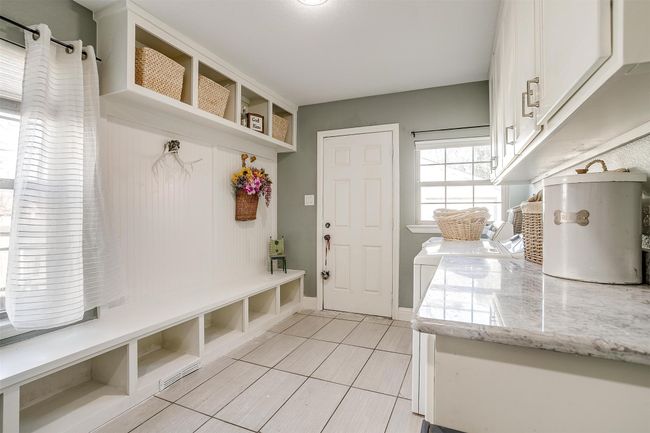 Mudroom with baseboards and light tile patterned floors | Image 11