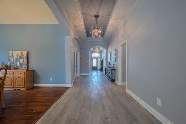 As you walk down the foyer toward the main living area, you'll pass the study/home office and the elegant dining room. | Image 8