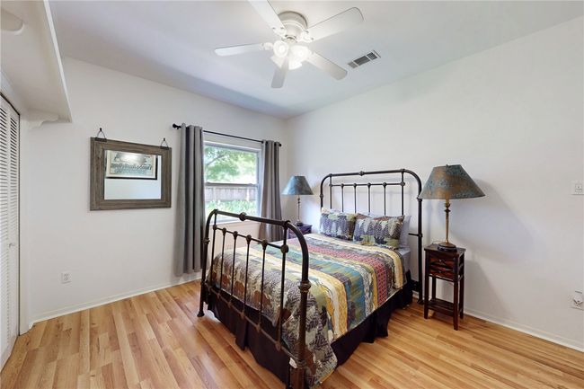 Bedroom with ceiling fan, baseboards, visible vents, and light wood-style flooring | Image 22