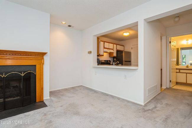 Living area looking to the kitchen and half bath | Image 8