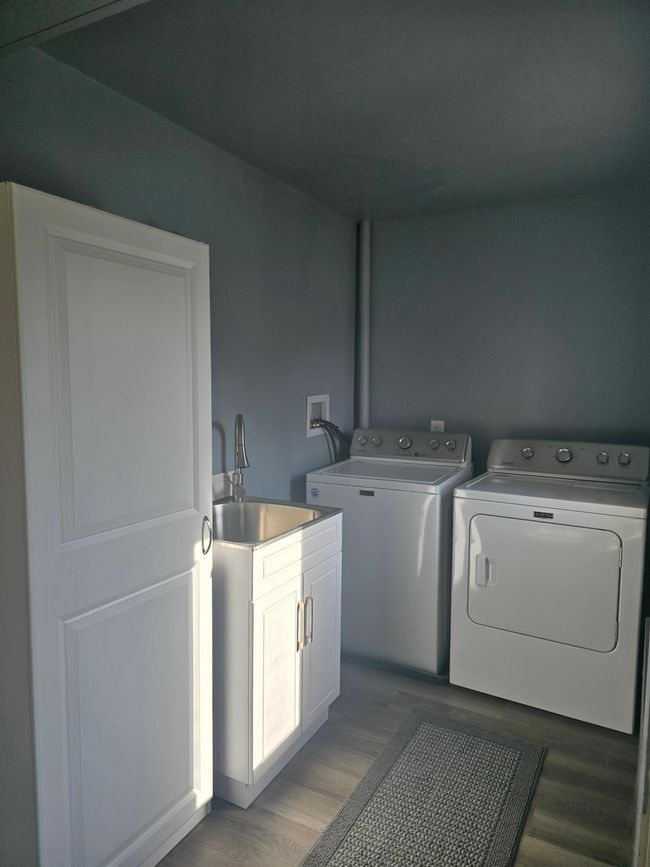 Convenient main floor laundry (washer & dryer go with seller) | Image 11