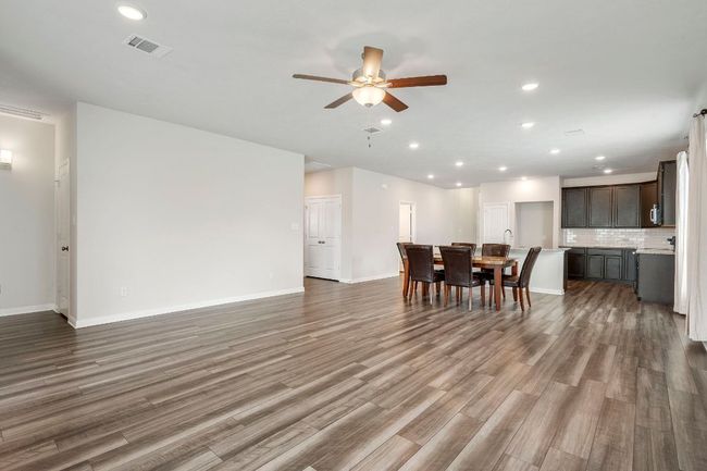 Dining room with recessed lighting, dark wood-type flooring, and ceiling fan | Image 5