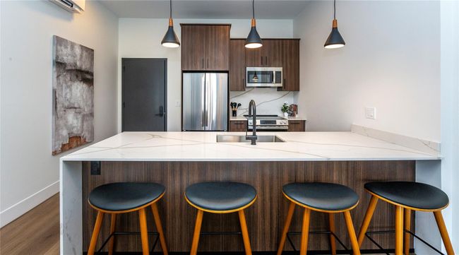 All twelve of the 2 bedroom units boast an island with pendant lighting, and seating for four. Electric outlet in the left hand top corner under the island. | Image 12