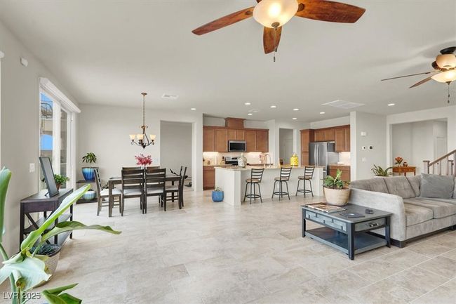 Living room featuring a ceiling fan, recessed lighting, and a chandelier | Image 14