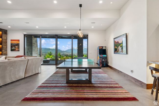 Dining room featuring a mountain view, recessed lighting, finished concrete floors, and baseboards | Image 49