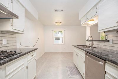 Kitchen had new flooring put down in 2020, and it has a dining area with a view of the back yard. | Image 3