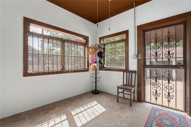 Back door leading to parking pad and detached garage. | Image 14