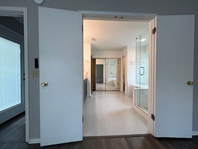 Hallway with dark wood-style flooring and baseboards | Image 19