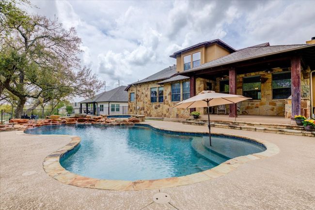View of gorgeous pool, hot tub and covered patio facing east for afternoon shade | Image 34