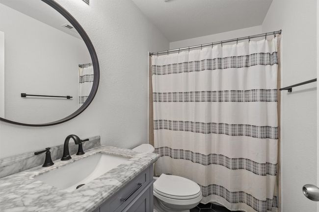 Bathroom with vanity and a shower with shower curtain | Image 28