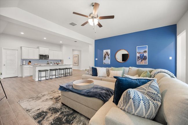 Living room featuring ceiling fan, light wood finished floors, and recessed lighting | Image 12