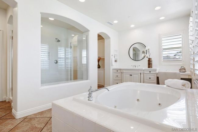Large primary bath with dual sinks, soaking tub and large shower area. | Image 12