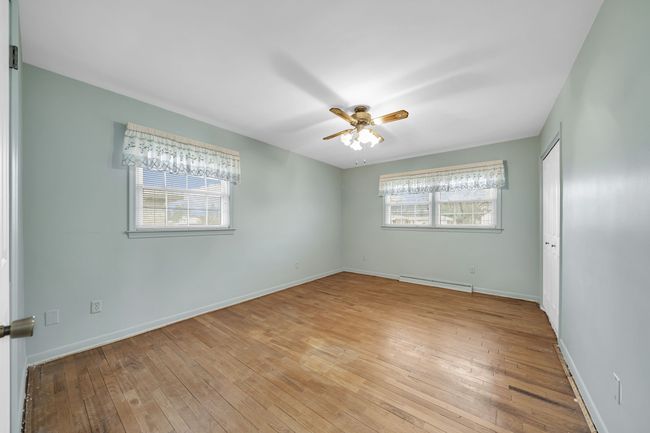 Primary Bedroom shows of the Warm Wood floors | Image 15