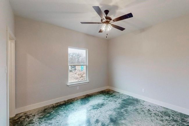 Carpeted spare room featuring ceiling fan and baseboards | Image 23