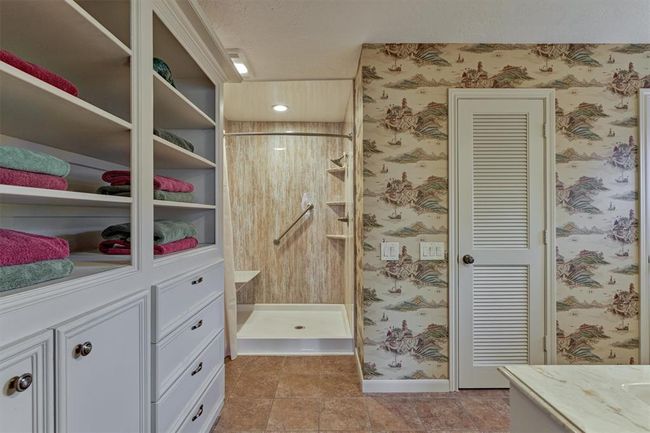 The primary en-suite bath includes built-in storage, dual closets, a walk-in shower, and a separate toilet room for added privacy. | Image 21
