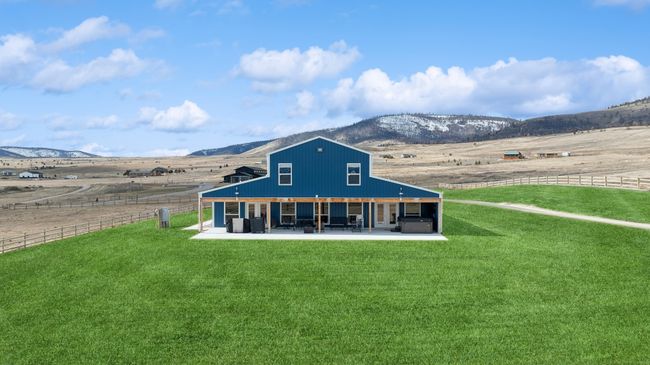 Back of house with a patio, a yard, a rural view, and a mountain view | Image 56