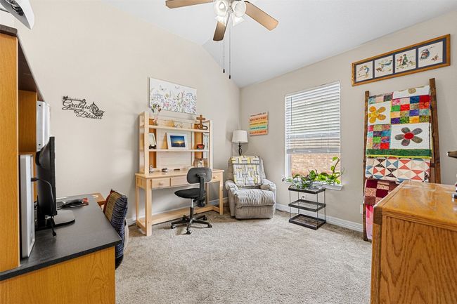 Office area with vaulted ceiling, carpet floors, ceiling fan, and baseboards | Image 26