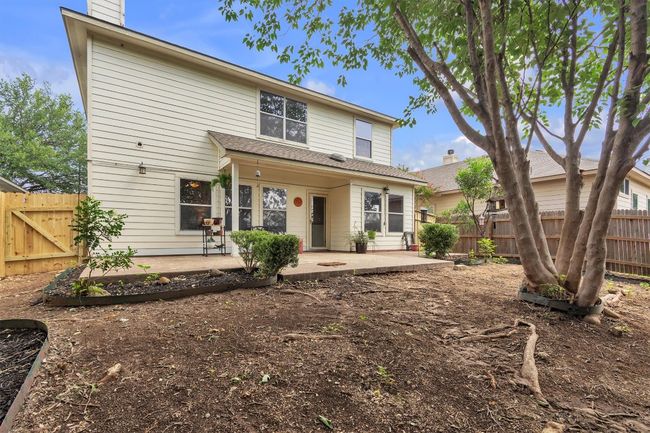 Alternate view of the backyard, you can see the new portion of the fence to the left, compared to the original fence to the right, again we didn't have the money to replace the grass in the back but we did have the trees trimmed, roof replaced May of 2025 | Image 26